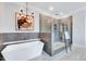 Beautiful bathroom showcasing a modern tub, glass enclosed shower, and elegant fixtures at 1309 Pecora Ln, Raleigh, NC 27607
