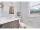 Stylish bathroom with a neutral color palette, modern fixtures, and a framed mirror at 1309 Pecora Ln, Raleigh, NC 27607