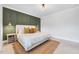 Serene bedroom with a plush bed, natural rug, and accent wall with elegant sconces at 1309 Pecora Ln, Raleigh, NC 27607