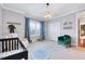 Bedroom featuring light walls, stylish decor, a crib, and natural light at 1309 Pecora Ln, Raleigh, NC 27607