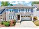 Charming two-story home with a two-car garage, landscaped yard, and beautiful architectural details at 1309 Pecora Ln, Raleigh, NC 27607