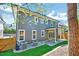 Charming home exterior featuring a covered patio, well-maintained lawn, and stylish gray siding at 1309 Pecora Ln, Raleigh, NC 27607