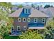 Rear view of home featuring upper dormer, covered patio, and lush landscaping at 1309 Pecora Ln, Raleigh, NC 27607