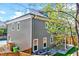 Rear exterior view featuring gray siding, well-kept yard, and covered patio at 1309 Pecora Ln, Raleigh, NC 27607