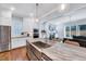 Gourmet kitchen featuring an island with seating, stainless appliances and white cabinets and eat in area at 1309 Pecora Ln, Raleigh, NC 27607