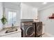 Efficient laundry room with modern washer, dryer, sink, and ample storage cabinets at 1309 Pecora Ln, Raleigh, NC 27607