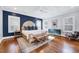 Spacious main bedroom featuring a plush bed, dark blue accent wall, and hardwood floors at 1309 Pecora Ln, Raleigh, NC 27607