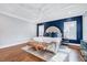 Spacious main bedroom featuring a plush bed, dark blue accent wall, and hardwood floors at 1309 Pecora Ln, Raleigh, NC 27607