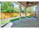 Relaxing covered patio area with stone floors and view of the fenced backyard at 1309 Pecora Ln, Raleigh, NC 27607