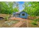 A beautifully landscaped backyard including a patio with stone walkways at 1487 Kentucky Ave, Sanford, NC 27332
