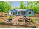 Charming blue home with backyard patio, firepit, and lush green landscaping at 1487 Kentucky Ave, Sanford, NC 27332