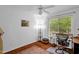 Bright bedroom with a ceiling fan, a large window, and a hardwood floor with an area rug at 1487 Kentucky Ave, Sanford, NC 27332