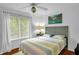 Bright bedroom with a ceiling fan and large window providing ample natural light at 1487 Kentucky Ave, Sanford, NC 27332