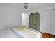 This is a charming bedroom with warm wood floors and a large, decorative armoire at 1487 Kentucky Ave, Sanford, NC 27332