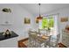 Bright dining room with hardwood floors, stylish lighting fixture, and large window with a view of the outdoors at 1487 Kentucky Ave, Sanford, NC 27332