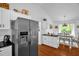 Kitchen area featuring stainless steel refrigerator with water dispenser and a breakfast bar at 1487 Kentucky Ave, Sanford, NC 27332