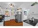 Bright kitchen features stainless steel appliances, white cabinets, and access to the laundry room at 1487 Kentucky Ave, Sanford, NC 27332