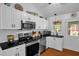 Kitchen featuring stainless steel appliances, granite counters, and a window over the sink at 1487 Kentucky Ave, Sanford, NC 27332