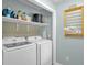 Functional laundry room featuring a new washer and dryer and storage shelves at 1487 Kentucky Ave, Sanford, NC 27332