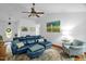 Bright living room featuring a vaulted ceiling, ceiling fan, hardwood floors, stylish furnishings, and natural light at 1487 Kentucky Ave, Sanford, NC 27332