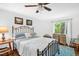 Inviting main bedroom featuring a wrought iron bed and a window with backyard views at 1487 Kentucky Ave, Sanford, NC 27332