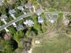 Aerial view of a residential neighborhood with a golf course winding through the trees at 1500 St Andrews Dr, Mebane, NC 27302