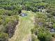 Scenic aerial shot of a golf course, pond, and surrounding lush green landscape at 1500 St Andrews Dr, Mebane, NC 27302