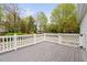 A view of a spacious deck and the surrounding landscape with lush greenery and mature trees at 1500 St Andrews Dr, Mebane, NC 27302
