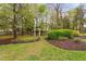 A peaceful backyard features an arbor, garden, and mature trees providing shade and privacy at 1500 St Andrews Dr, Mebane, NC 27302