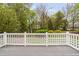 Relax on the home's deck and enjoy this landscaped backyard with mature trees and lush greenery at 1500 St Andrews Dr, Mebane, NC 27302