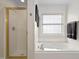 Bright bathroom with a large soaking tub and glass enclosed shower at 1500 St Andrews Dr, Mebane, NC 27302