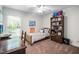 Bright bedroom featuring a cozy single bed, bookshelf, desk and window at 1500 St Andrews Dr, Mebane, NC 27302
