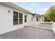A gray wooden deck has white railings and provides a relaxing outdoor space, complementing the home's exterior at 1500 St Andrews Dr, Mebane, NC 27302