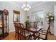 Elegant dining room featuring a beautiful chandelier, large window, and traditional furnishings at 1500 St Andrews Dr, Mebane, NC 27302