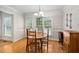 Bright dining area offers hardwood floors, neutral walls, and access to a deck at 1500 St Andrews Dr, Mebane, NC 27302