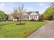 Beautiful home with a covered porch, well-maintained lawn, and mature trees at 1500 St Andrews Dr, Mebane, NC 27302
