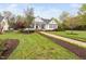 Attractive home featuring a covered porch, lush lawn, and neatly landscaped yard at 1500 St Andrews Dr, Mebane, NC 27302