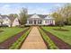 Inviting home with a walkway, manicured lawn, and a charming covered front porch at 1500 St Andrews Dr, Mebane, NC 27302