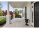 Relaxing front porch showcasing a porch swing, black shutters, white columns, and an inviting entrance at 1500 St Andrews Dr, Mebane, NC 27302