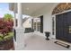Charming front porch featuring a swing, white columns, black shutters, and an inviting entrance at 1500 St Andrews Dr, Mebane, NC 27302