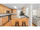 Eat-in kitchen with wood cabinets, stainless steel appliances, and a breakfast bar with seating at 1500 St Andrews Dr, Mebane, NC 27302