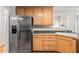 Kitchen featuring wood cabinets, stainless steel refrigerator, and ample counter space at 1500 St Andrews Dr, Mebane, NC 27302