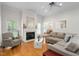 Cozy living room featuring a fireplace, hardwood floors, and a comfortable seating area at 1500 St Andrews Dr, Mebane, NC 27302