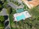 Aerial view of the community pool with lounge chairs and a green roofed building at 1500 St Andrews Dr, Mebane, NC 27302