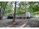 Backyard with a lush green lawn, mature trees, and a deck at 1536 Dirkson Ct, Cary, NC 27511