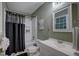 Bathroom with tub, shower, vanity, and olive green wood paneled walls at 1536 Dirkson Ct, Cary, NC 27511
