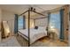 Charming primary bedroom with decorative four-poster bed, fan, and ample natural light at 1536 Dirkson Ct, Cary, NC 27511