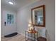 Bright foyer with light hardwood floors, white trim, and a stylish mirror creating an inviting entry at 1536 Dirkson Ct, Cary, NC 27511