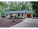 Charming ranch home with a yellow front door, black shutters, and an attached one-car garage at 1536 Dirkson Ct, Cary, NC 27511