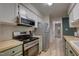 A well-equipped kitchen featuring stainless steel appliances and bright, clean countertops at 1536 Dirkson Ct, Cary, NC 27511